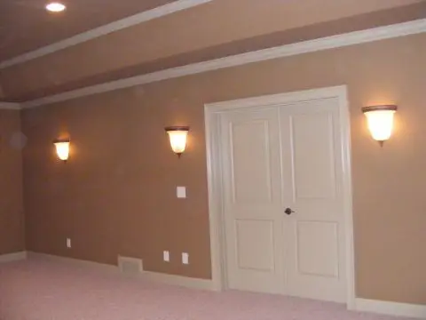 A room with two lights and a door.