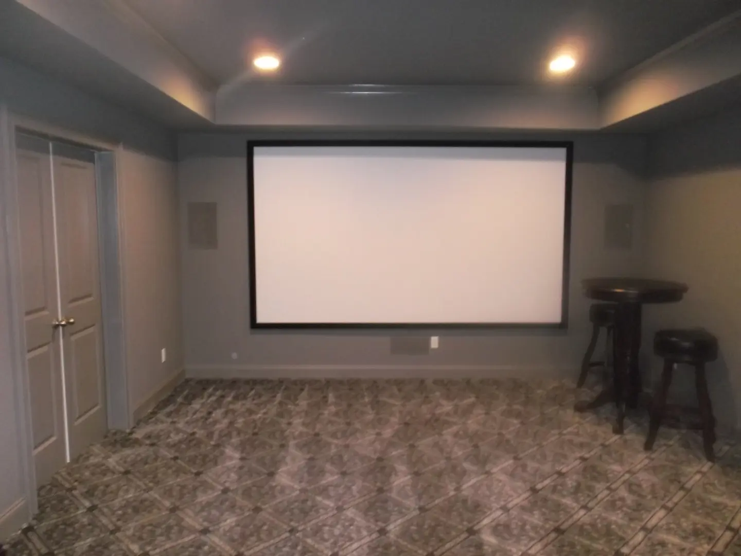A large screen projector in the middle of a room.