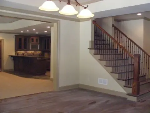 A room with stairs and hardwood floors in it
