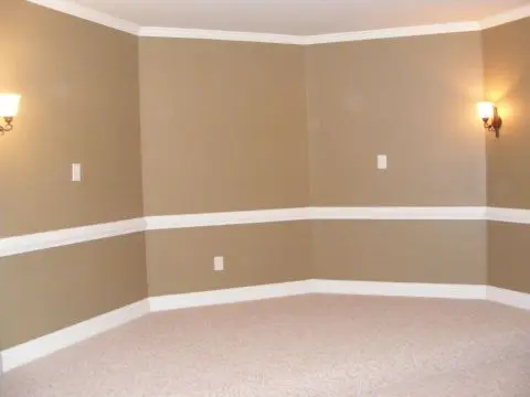 A room with two walls and a white trim.