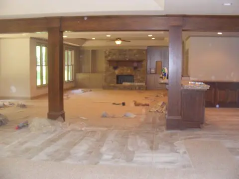 A room with wood beams and tile floors.