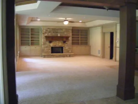 A room with a fireplace and a large open floor plan.