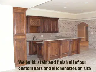A kitchen with wooden cabinets and granite counter tops.