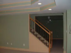 A room with stairs and green walls