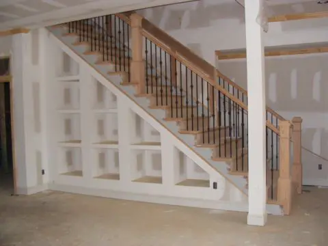 A staircase with wooden steps and metal railing.