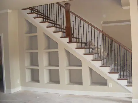 A staircase with metal railing and wooden steps.