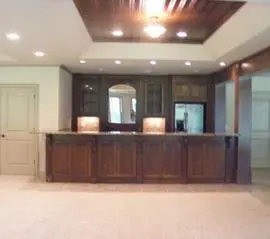 A large room with wooden cabinets and a counter.