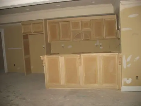 A room with wooden cabinets and doors in it