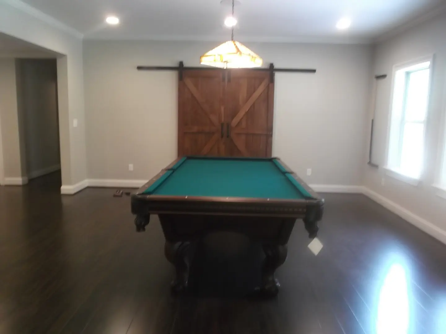 A pool table in the middle of a room.
