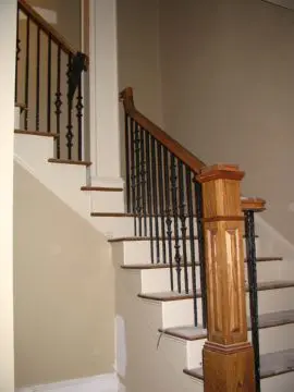 A staircase with wood and metal railing.
