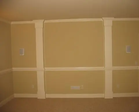 A room with three different colored walls and two white trim.