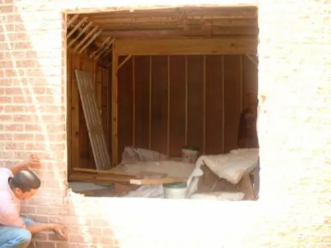 A window in the wall of an unfinished room.