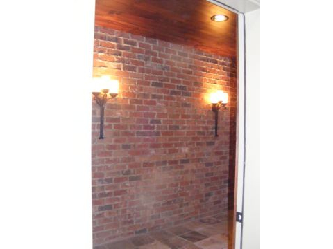 A brick wall with lights on the side of it.