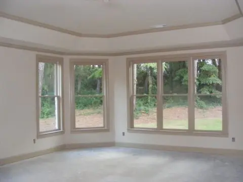A room with three windows and a floor.