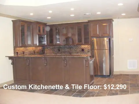 A kitchen with brown cabinets and marble counter tops.