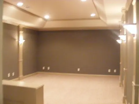 A room with lights on the wall and a white couch