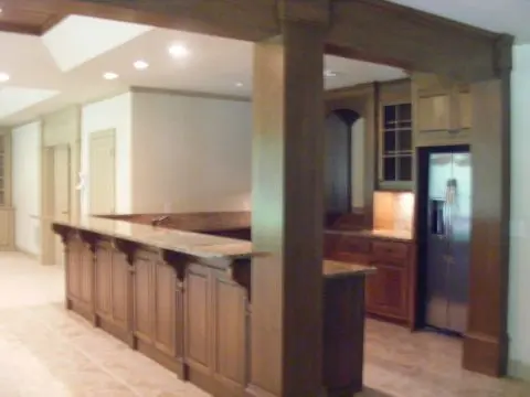 A kitchen with wooden cabinets and a refrigerator.