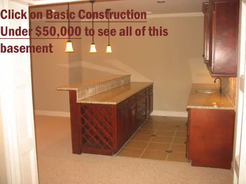 A kitchen with brown cabinets and tile floor.
