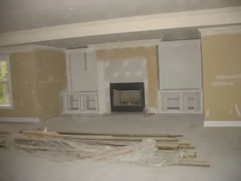 A room with some cabinets and a fireplace