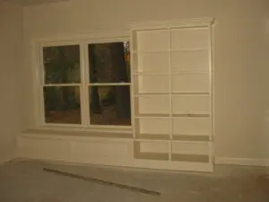 A window sill with some shelves in front of it