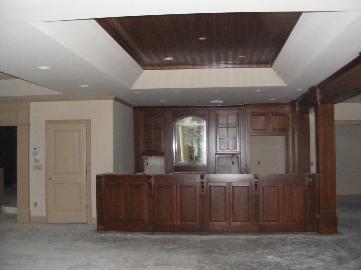 A room with wood cabinets and a ceiling.