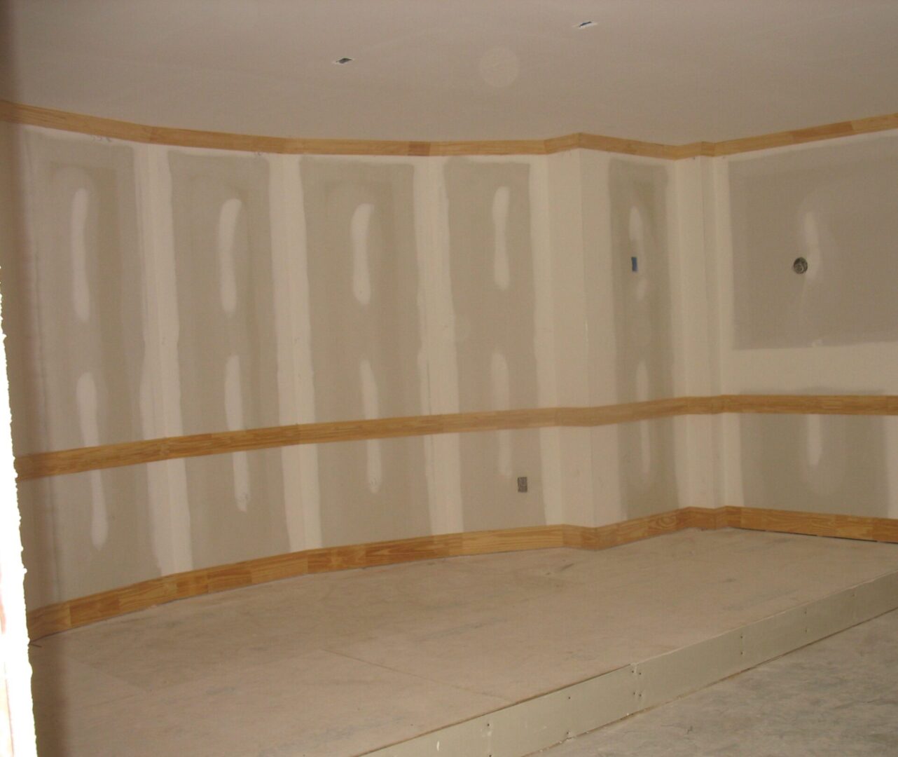 A room with walls being painted white and yellow.
